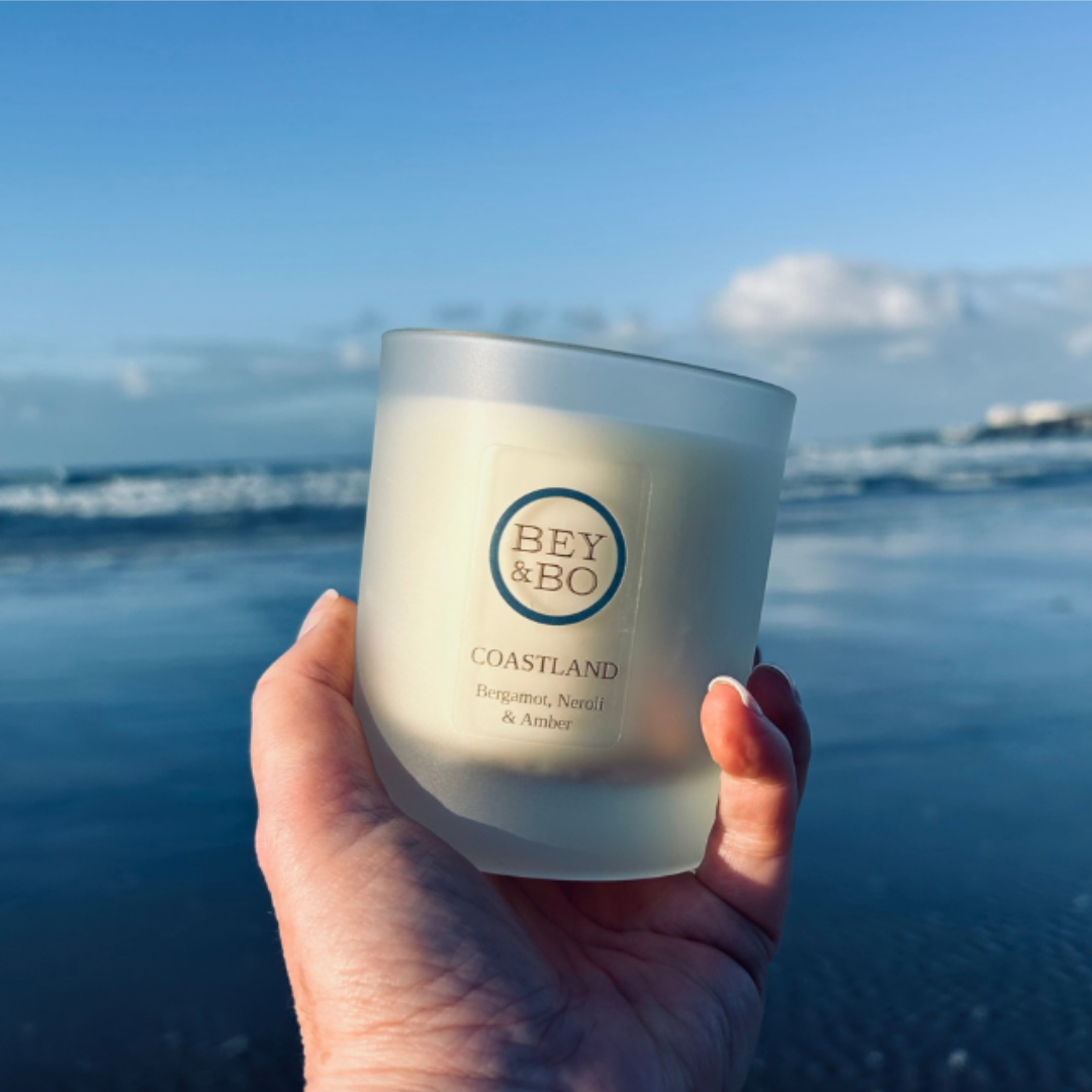 Coastland Candle in front of beach